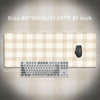 Beige plaid pattern non-slip mouse pad with a black computer mouse and keyboard