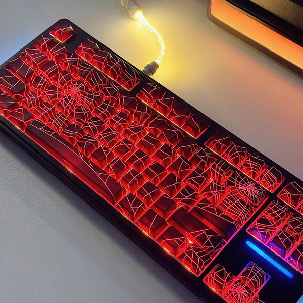 A close-up view of a red mechanical keyboard with translucent keycaps illuminated by a bright light.
