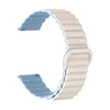 A white adjustable magnetic loop watch band shown in a curved shape.