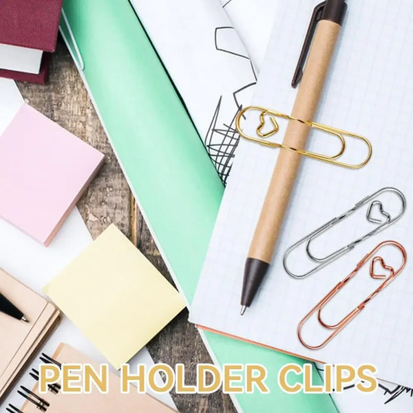 A collection of elegant metal pen holder clips arranged on a green notebook and white paper.