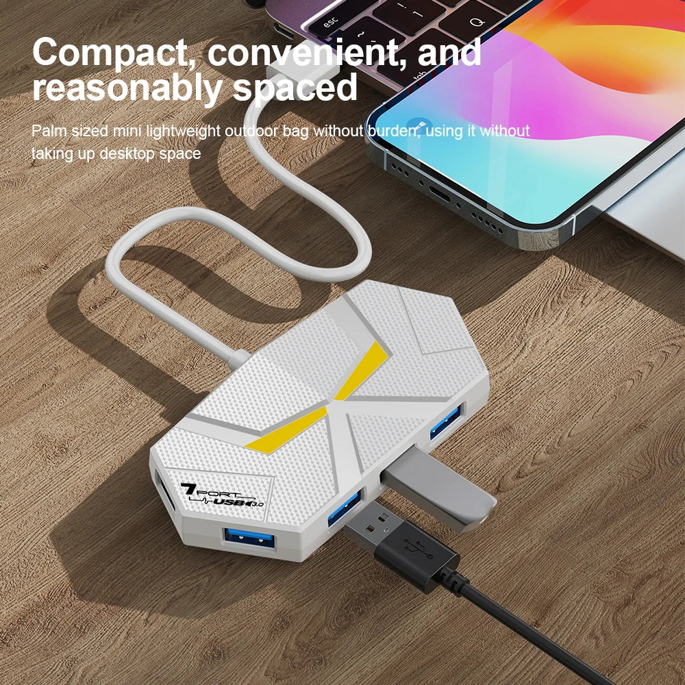 A white compact USB 3.0 multi-port hub with a Type-C power port is shown on a wooden desk next to a smartphone.