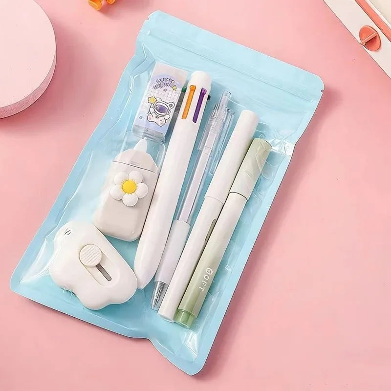A light blue plastic case holds a set of cute cartoon school stationery including pens and an eraser.