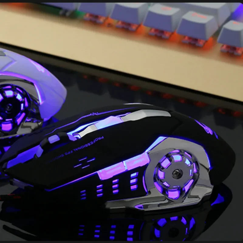 A close-up view of a black and purple wireless computer mouse with illuminated accents on a reflective surface.