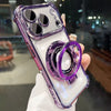 A purple iPhone case with a magnetic stand and lens protection is held in a hand against a blurred background.