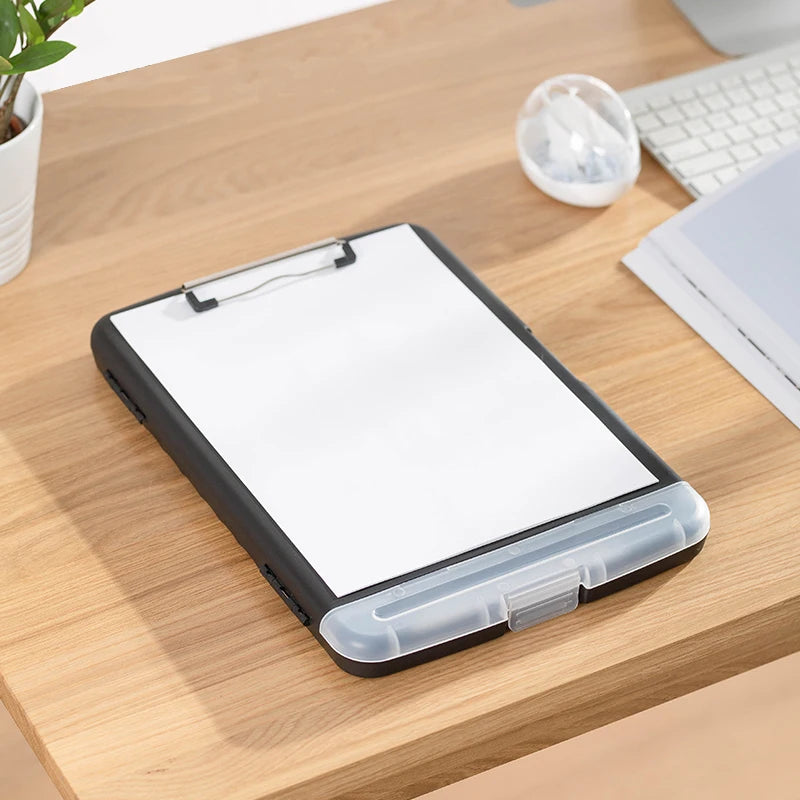 A black A4 waterproof file box with a writing board and pen slot resting on a wooden desk.