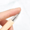 A hand holds a precision craft knife set with a silver blade and beige handle.