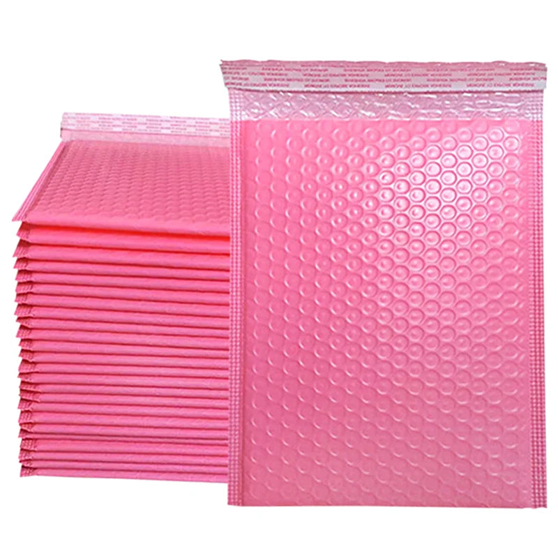 A stack of pink padded bubble mailers with self-seal closures.