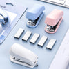 A collection of mini staplers and various sizes of staples displayed on a light blue surface.
