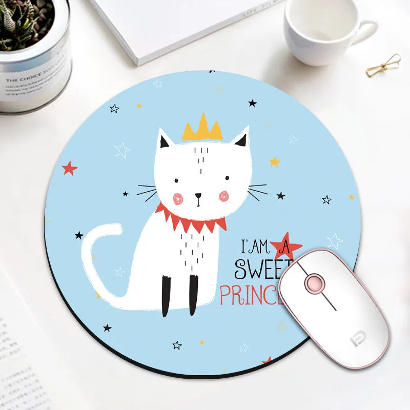 A round blue mouse pad featuring a white cat crown design and the text I am a sweet prince.