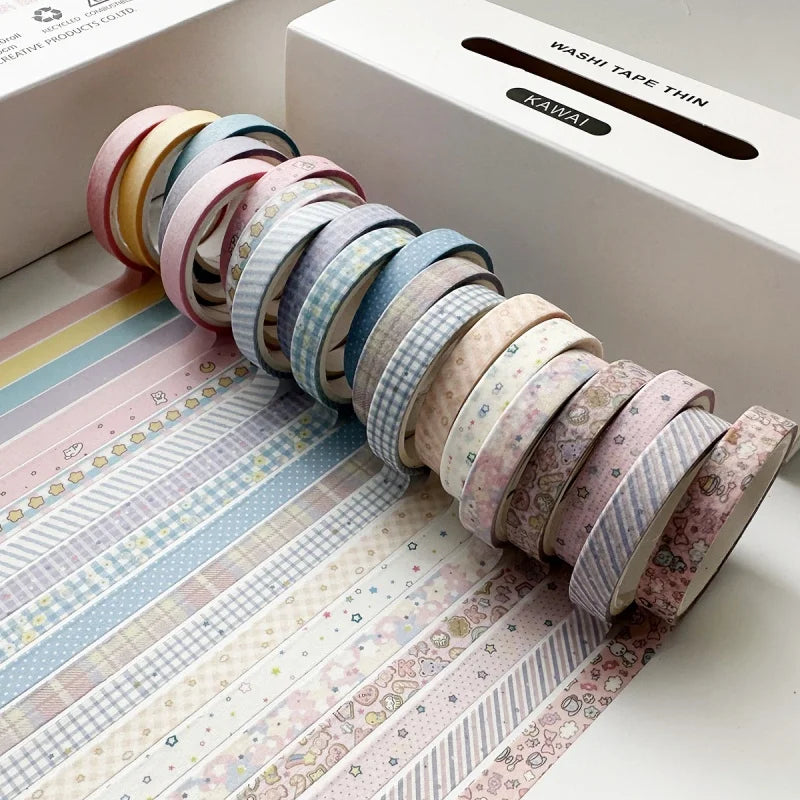 A collection of colorful retro washi tape rolls arranged diagonally on a patterned paper, next to its packaging.