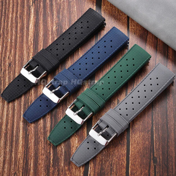 A collection of perforated silicone watch straps in various colors including black, navy blue, dark green, and gray.