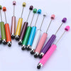 A collection of colorful rubber touch ballpoint pens with various colored barrels and tips arranged diagonally.