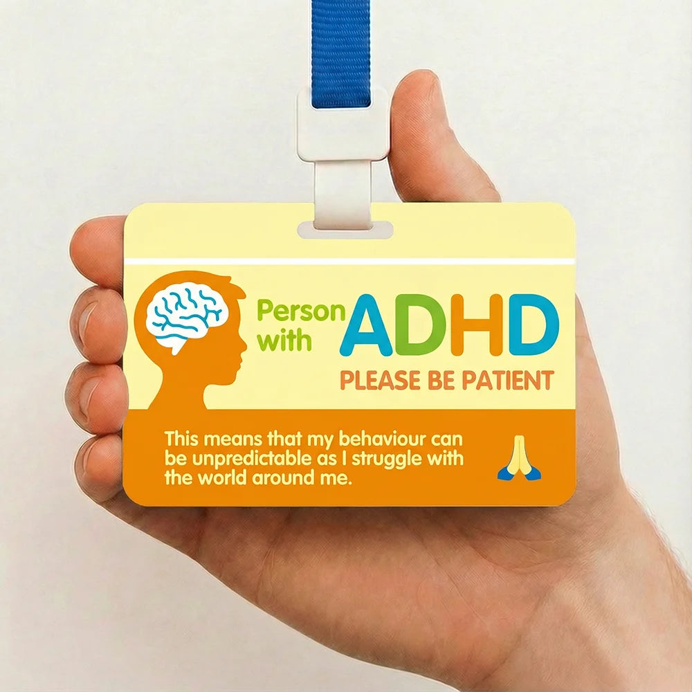 A yellow awareness card for people with ADHD with a blue lanyard being held in a hand.