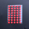 A rectangular sheet of 40 red adhesive glide feet for universal mouse skates.