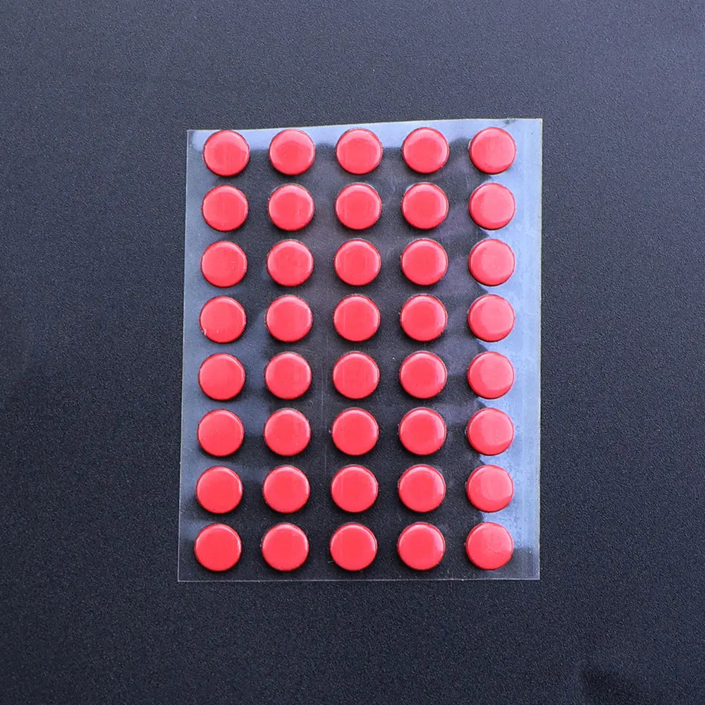 A rectangular sheet of 40 red adhesive glide feet for universal mouse skates.