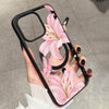 A hand holds a pink lily floral transparent iPhone case with a shockproof bumper.