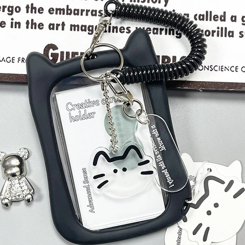 A black crystal clear card holder with a cat charm attached to a keychain.
