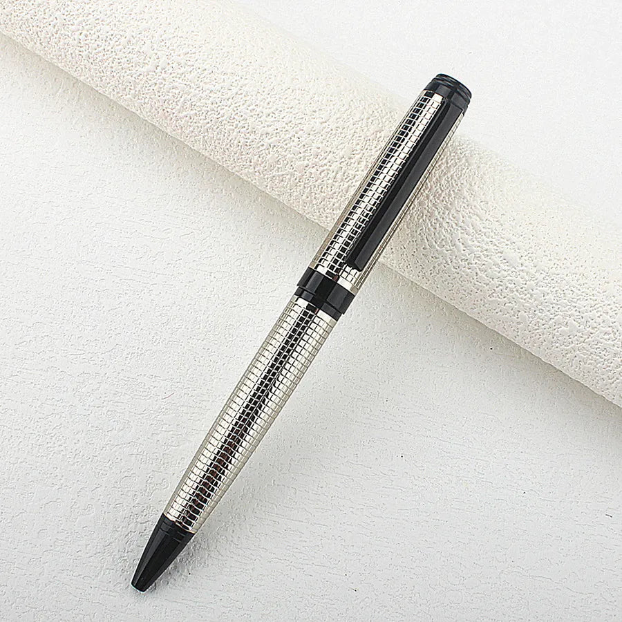 A silver and black metal ballpoint pen is shown diagonally against a white background.