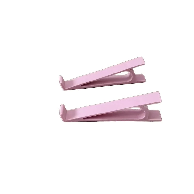 Ein Paar rosa ergonomischer Tastenhöhenverstellstrecker.