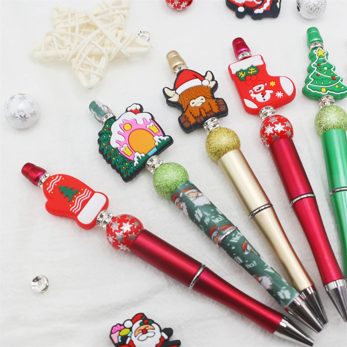 A set of decorative beaded ballpoint pens featuring Christmas and festive designs.