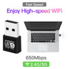 A white USB WiFi adapter is shown next to a laptop, illustrating high-speed Wi-Fi connectivity.