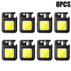 Eight compact COB keychain flashlights with magnetic bases and rechargeable batteries.