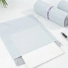 A stack of clear self-adhesive sealed packing bags with a purple ribbon detail on the top roll.