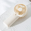 A white portable rechargeable mini handheld fan with a circular grille and a cord resting on a white surface.