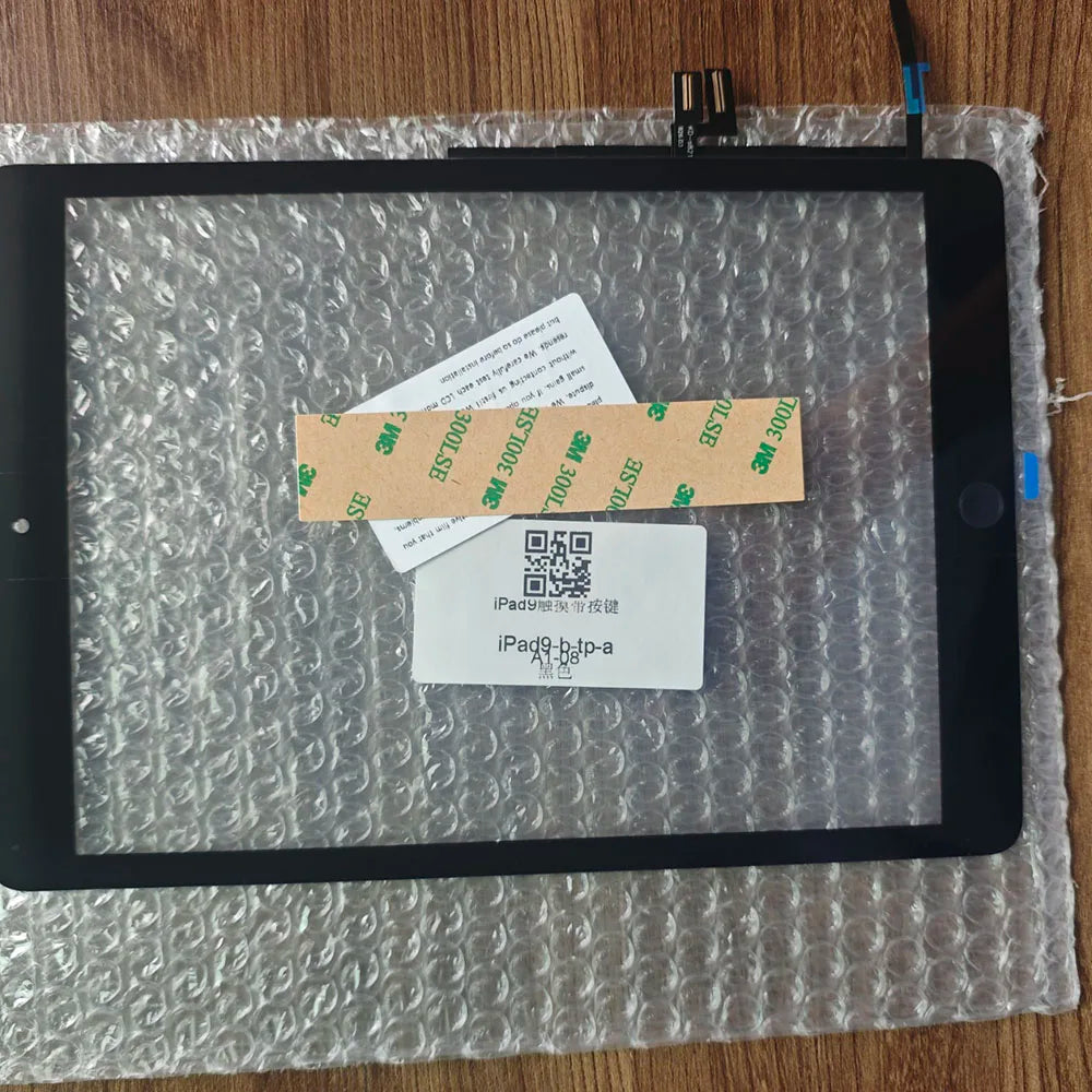 An iPad screen is visible, covered in protective film, with several small cards placed on the display.