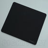 A black professional gaming mouse pad desk mat viewed from above.