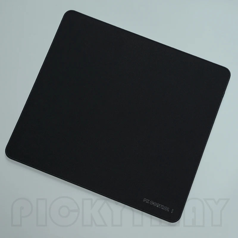 A black professional gaming mouse pad desk mat viewed from above.