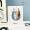 A white photo card binder with a clear window showing a silhouette of a bear against a cloudy sky and sunset.