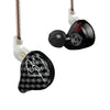 A pair of black wired headphones with silver accents and a gold-colored cable hanging from a stand.