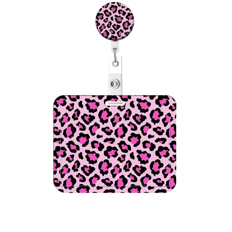 A pink leopard print retractable badge holder with a silver clip.