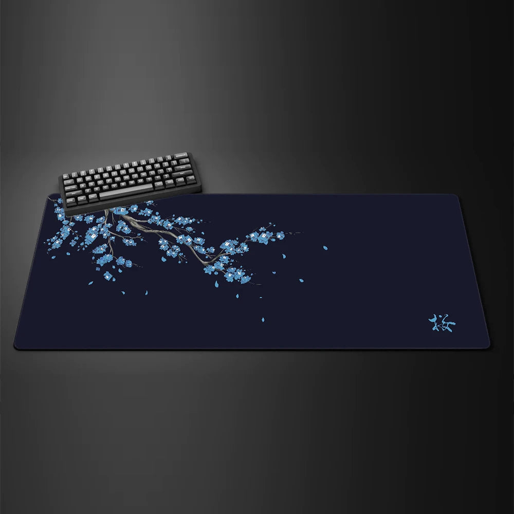 A dark blue gaming mouse pad featuring a delicate white cherry blossom branch design and a small silhouette of a bird.