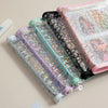 A stack of transparent zipper photo binders in various pastel colors and designs for cards and keepsakes.