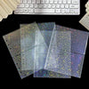 A stack of clear, iridescent photo sleeves with glitter and holographic effects are displayed next to a computer keyboard.