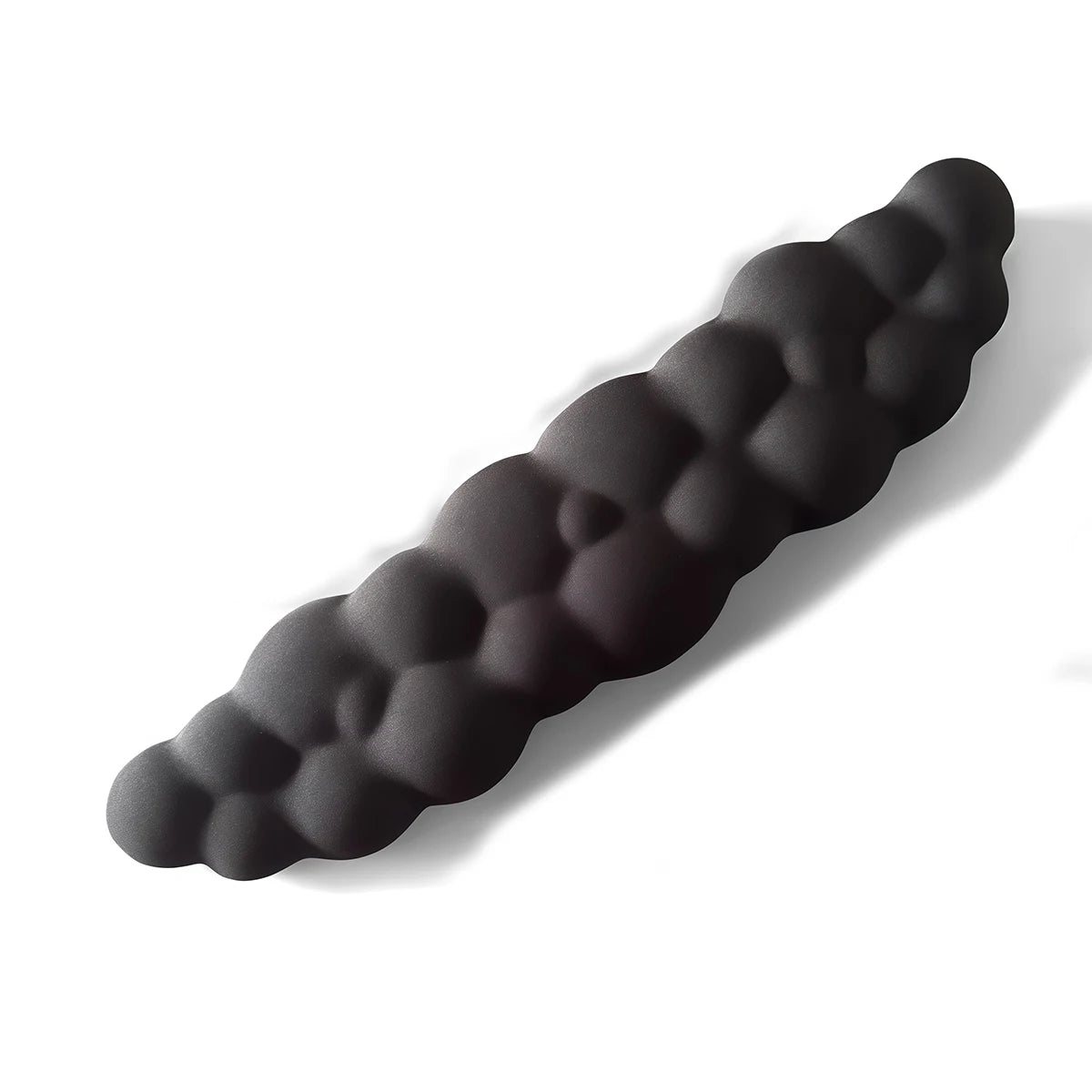 A black ergonomic memory foam wrist rest pad for desk and mouse, shown in profile.