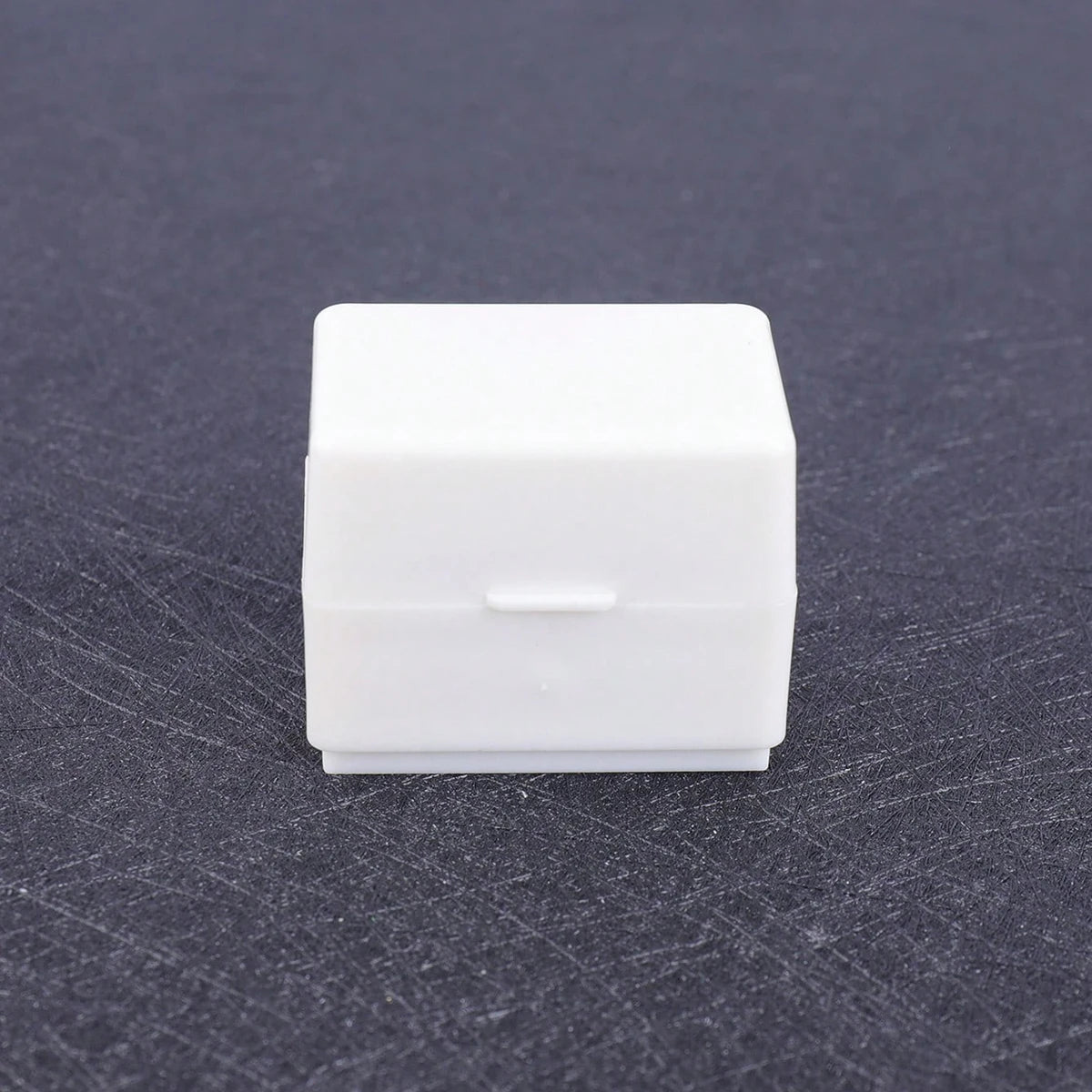 A white privacy protection roller stamp is shown on a dark gray surface.