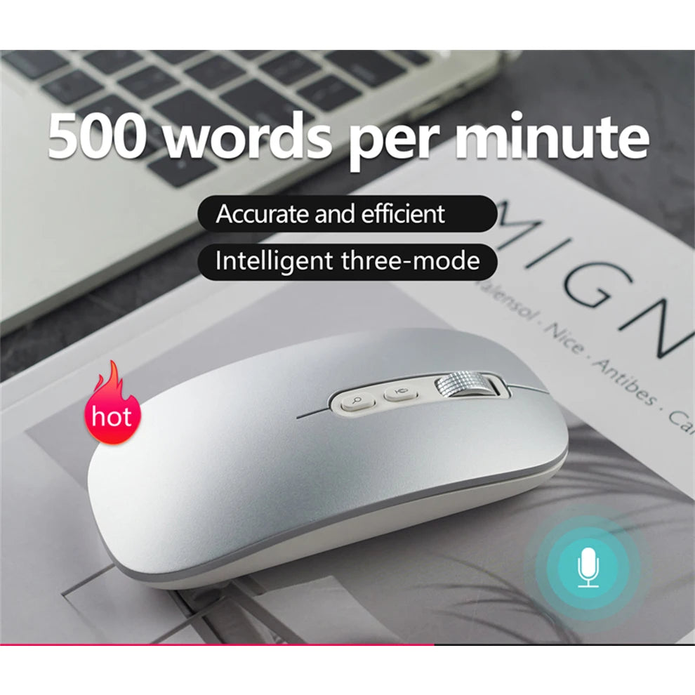 A white AI voice typing mouse is shown on a desk next to a laptop keyboard.