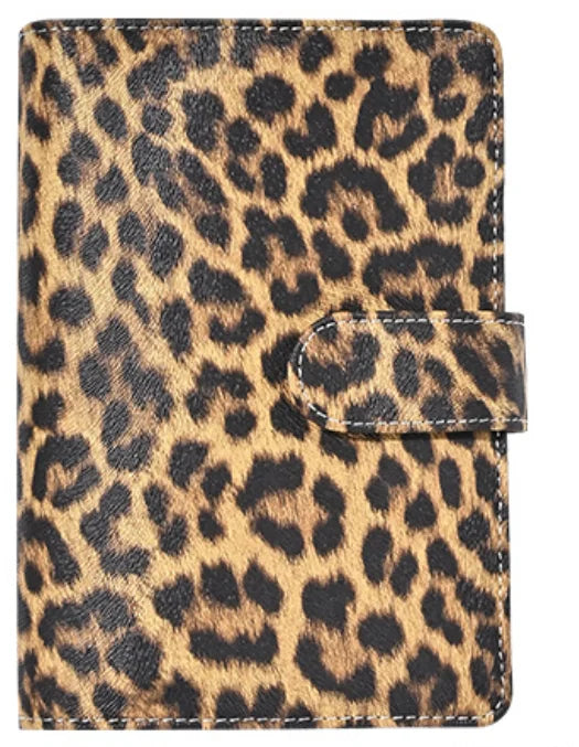 A leopard print A6 binder with a black elastic closure and 6-hole loose leaf system.
