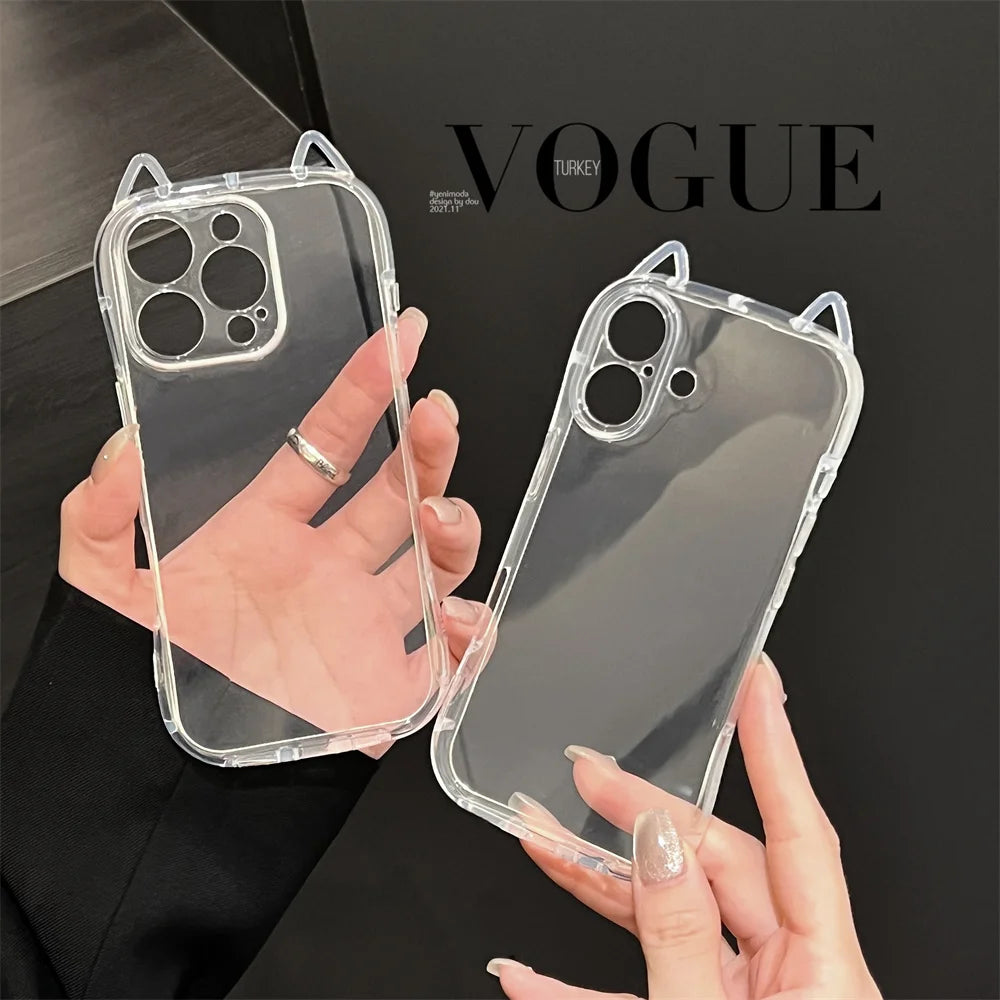 A hand holds a clear silicone case for an iPhone with 3D cat ears design against a dark background.