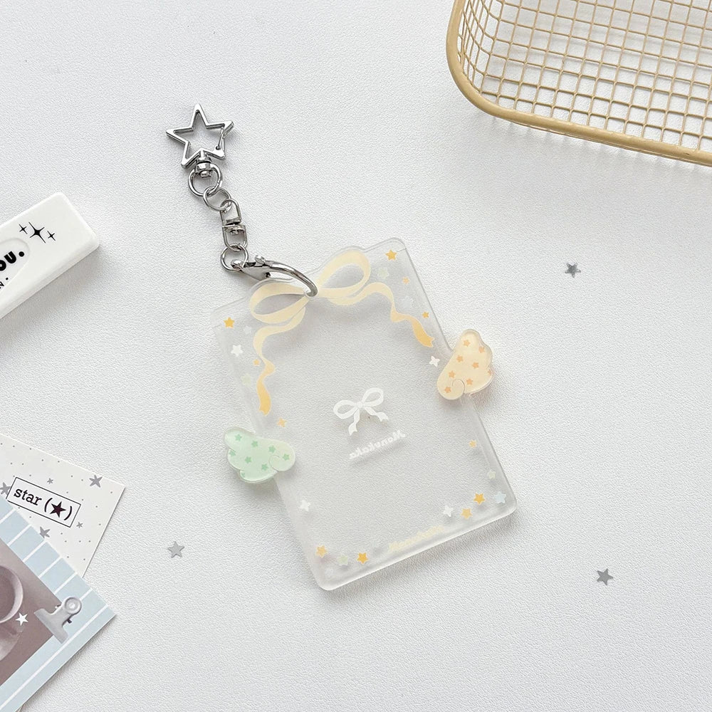 Clear acrylic card holder with a yellow ribbon and a silver star keychain