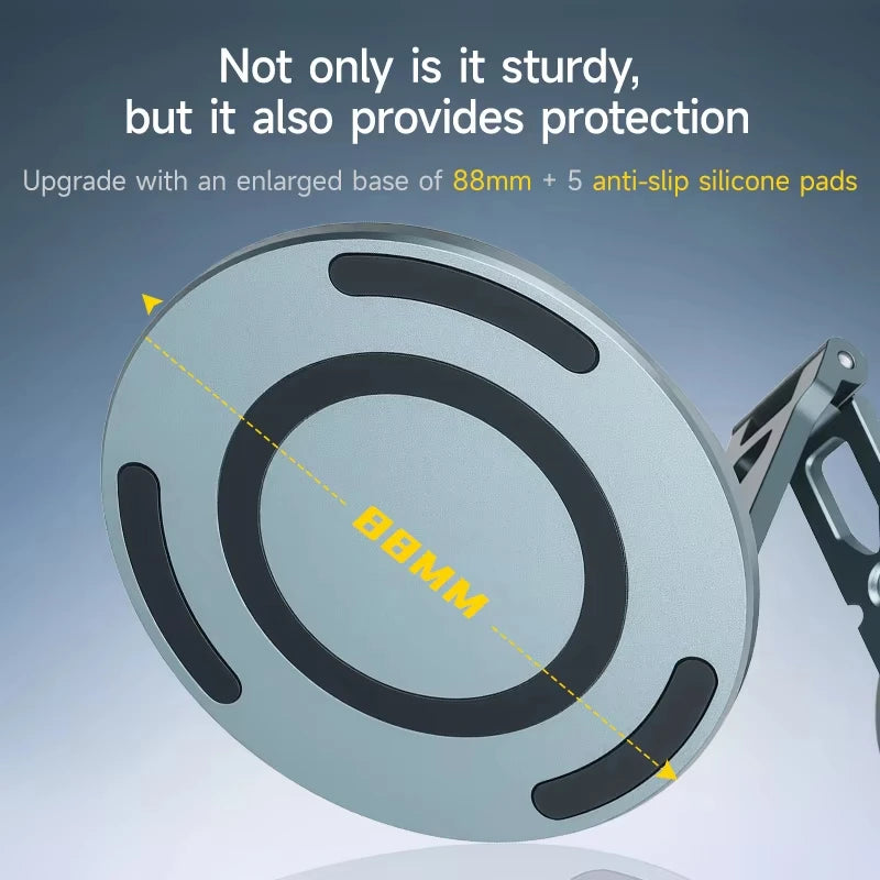 A close-up view of a round, silver magnetic phone stand with an enlarged base and anti-slip silicone pads.
