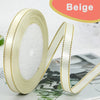 Roll of beige satin ribbon with gold edge and a matching ribbon strip