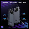 A black UGREEN Uno 6-in-1 USB C Hub showing various ports including USB-C PD, HDMI, and multiple USB-A connections.