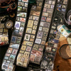 A collection of vintage stamp tape stickers and photographic elements for scrapbooking displayed on a dark surface.
