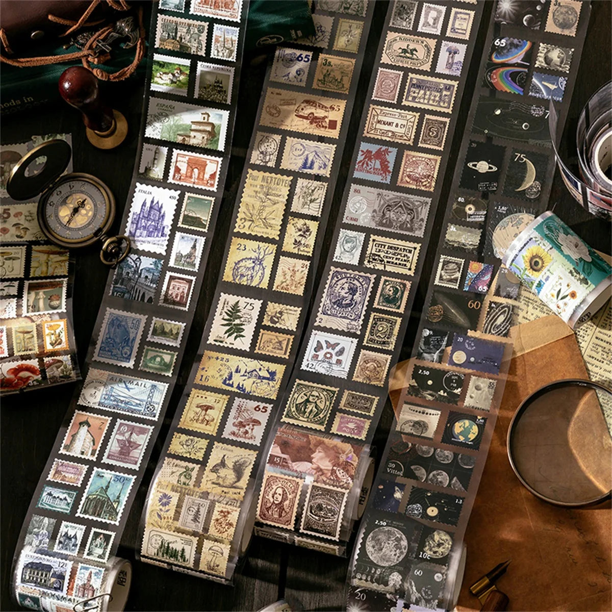 A collection of vintage stamp tape stickers and photographic elements for scrapbooking displayed on a dark surface.