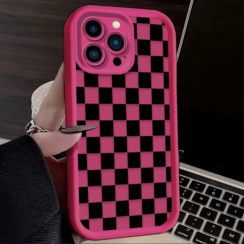 A pink phone case with a black and white checkered pattern is shown on a laptop.