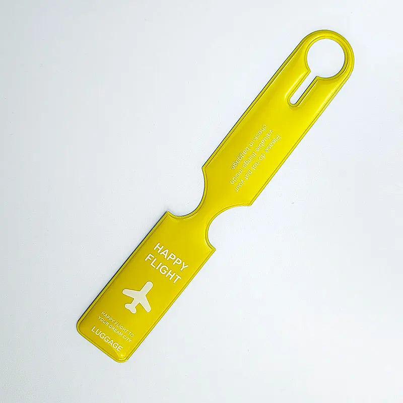 A bright yellow durable PVC luggage tag with a loop handle and text on the tag.